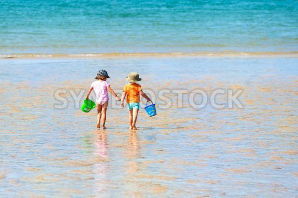 Two children playing on a sand beach at sea - GlobePhotos - royalty free stock images