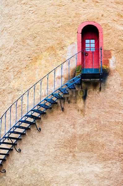 Decorated stairs leading to a door in terracotta wall - GlobePhotos - royalty free stock images