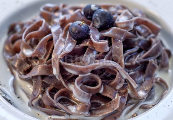 Blueberry tagliatelle pasta with cream sauce, italian cuisine - GlobePhotos - royalty free stock images