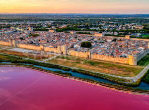 The pink salt lake and the medieval walled town of Aigues-Mortes, Camargue, France